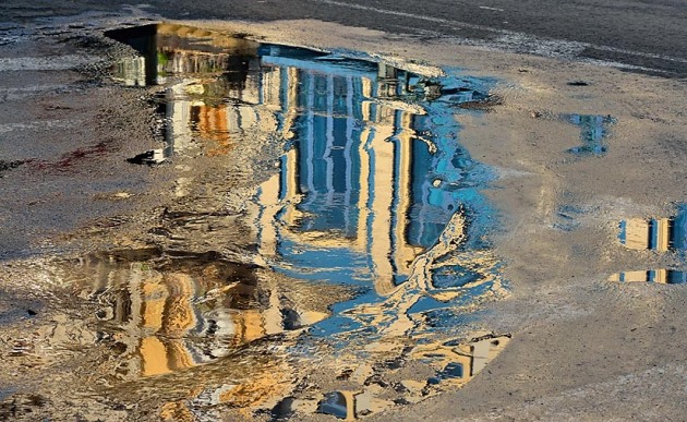 Street photogrphy in Old Havana- reflections in a water puddle